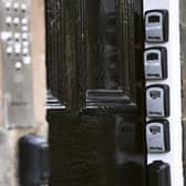 Key safes at the door of a block of flats in Edinburgh point to Airbnb-style holiday flats inside (Picture: Lisa Ferguson)
