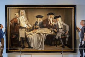 Dr Tacye Phillipson and Steven Anderson install the 1728 painting The Anatomy Lesson of Dr Willem Röell by Cornelis Troost at the National Museum of Scotland. On loan from Amsterdam Museum, it is one of more than 200 objects on display in Anatomy: A Matter of Death and Life. PIC: Neil Hanna Photography
