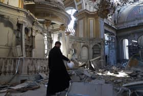 A priest examines damage to the Transfiguration Cathedral in Odesa following a Russian missile strike, July, 2023 PIC: Oleksandr Gimanov / AFP via Getty Images
