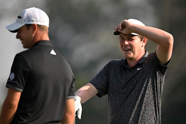 Bob MacIntyre shares a laugh with Guido Migliozzi, one of his playing partners, at DLF Golf and Country Club in India. Picture: Stuart Franklin/Getty Images.