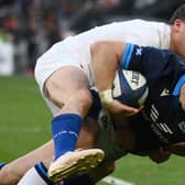 Scotland's centre Huw Jones scores a try as France's scrum-half Antoine Dupont attempts to tackle during the Six Nations match in Paris. (Photo by FRANCK FIFE/AFP via Getty Images)