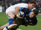 Scotland's centre Huw Jones scores a try as France's scrum-half Antoine Dupont attempts to tackle during the Six Nations match in Paris. (Photo by FRANCK FIFE/AFP via Getty Images)