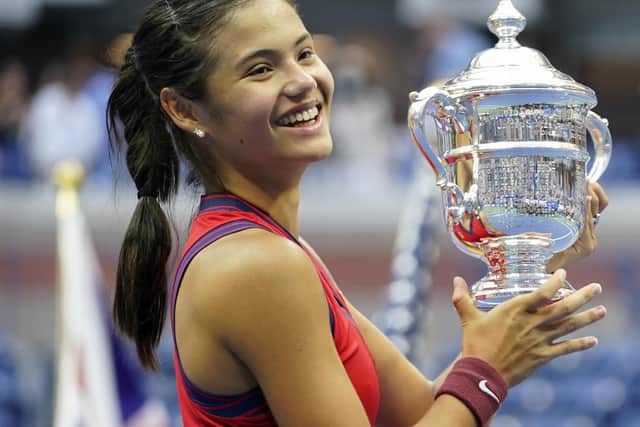 Emma Raducanu holds the trophy as she celebrates winning the women's singles final on day twelve of the US Open. Picture: PA