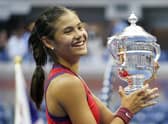 Emma Raducanu holds the trophy as she celebrates winning the women's singles final on day twelve of the US Open. Picture: PA