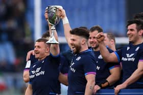 Ali Price of Scotland lift the Cuttitta Cup after a 33-22 Six Nations win over Italy.