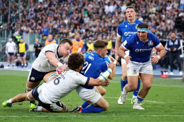 Italy's Stephen Varney scores his team's third try whilst under pressure from Andy Christie of Scotland.
