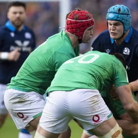 Scott Cummings is tackled by three Irish player during Scotland's defeat in the Six Nations clash.
