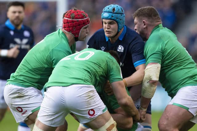 Scott Cummings is tackled by three Irish player during Scotland's defeat in the Six Nations clash.