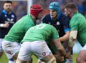 Scott Cummings is tackled by three Irish player during Scotland's defeat in the Six Nations clash.