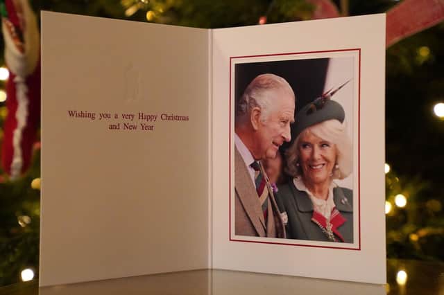 The 2022 Christmas card of King Charles III and the Queen Consort in front of a Christmas tree in Clarence House, London.