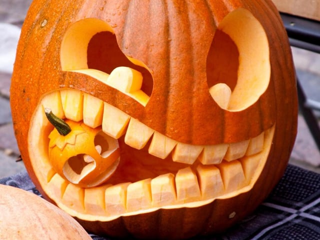 This design can be as complicated as you want it to be. To make it look as visually impressive as the one above will require some patience and skill with your carving - but even a basic pumpkin face with a miniature gourd popped on the mouth will make your pumpkin stand out this Halloween.