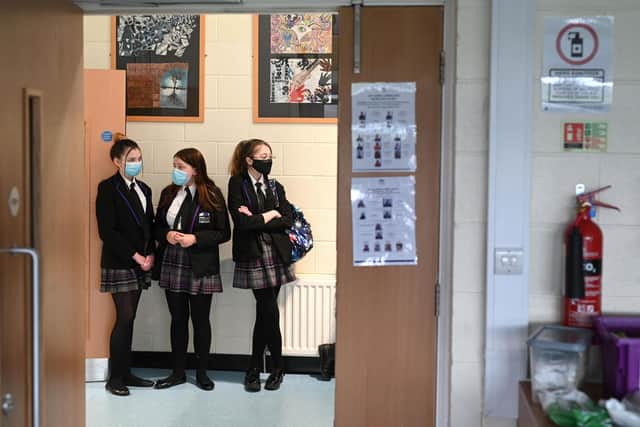 Students wait to enter a classroom. Photo by OLI SCARFF/AFP via Getty