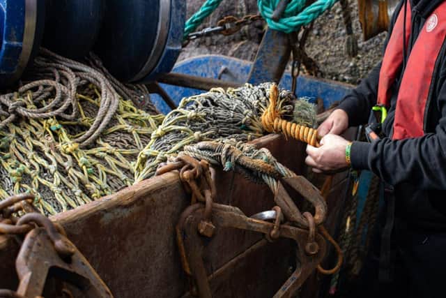 Fishermen mending a net
