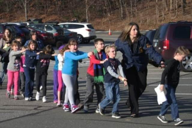Terrified children, many in tears, flee with staff as Sandy Hook Elementary School is evacuated