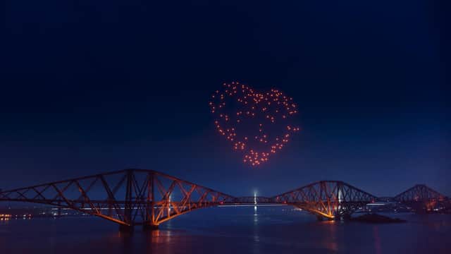 As part of Edinburgh's online Hogmanay celebrations, a swarm of drones forms a heart over the Forth Bridge