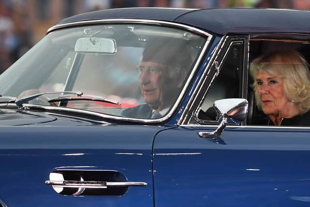 Prince Charles  drives with Camilla in an Aston Martin sports car into the opening ceremony for the Commonwealth Games