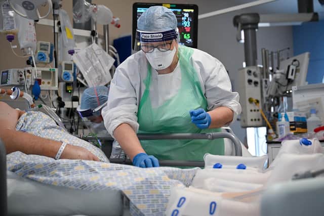 A member of staff at University Hospital Monklands attends to a Covid-positive patient on the ICU ward on February 5, 2021 in Airdrie, Scotland. Photo by Jeff J Mitchell/Getty Images