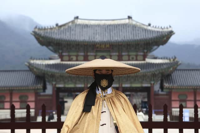 Facemasks are widely used across the world as a main part of the response to the Covid outbreak. Here, an Imperial guard at Gyeongbok Palace in Seoul, South Korea wears one while on duty (Picture: Ahn Young-joon/AP)