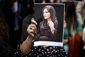 A protester holds a photograph of Mahsa Amini during a demonstration outside the Iranian embassy in Brussels (Picture: Kenzo Tribouillard/AFP via Getty Images)