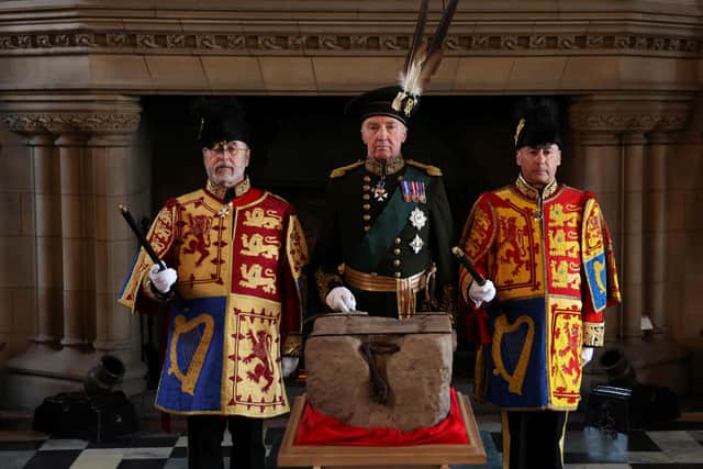 The Duke of Buccleuch (centre), flanked by two Officers of Arms, with the Stone of Destiny. The Duke is among those due to present the King's regalia on Saturday. PIC: 
 Russell Cheyne/PA Wire
