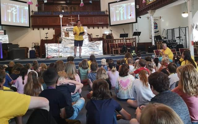 Matt Sinar, Fetteresso Church’s youth and children’s worker, talks with some of the children and leaders at one of the holiday club group sessions.