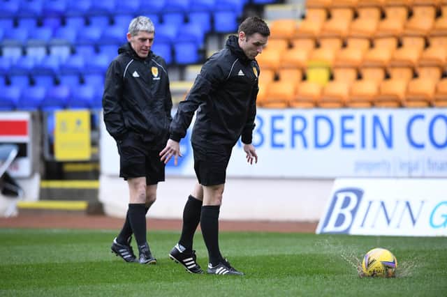 Referee Steven McLean conducts a pitch inspection before a cinch Premiership match between St Johnstone and Ross County.