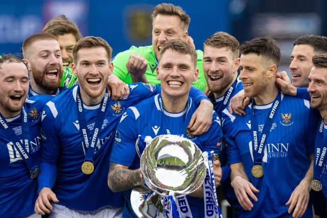 St Johnstone's Jason Kerr lifts the Betfred Cup trophy alongside McCart and team-mates on February 28 (Picture: SNS)