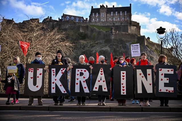Members of the public gather on Princes Street as part of an International Day of Solidarity with Ukraine on Sunday in Edinburgh. Photo by Jeff J Mitchell/Getty Images
