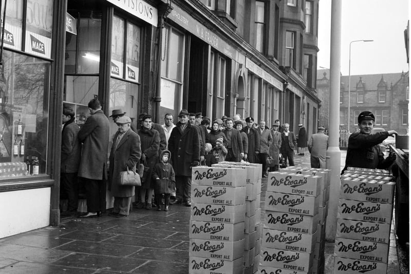 Customers queue outside Mr Munro's shop at Brandon Terrace in Edinburgh stocking up for Hogmanay