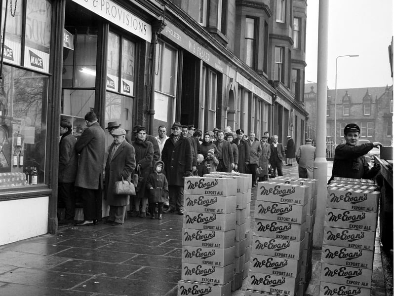 Customers queue outside Mr Munro's shop at Brandon Terrace in Edinburgh stocking up for Hogmanay