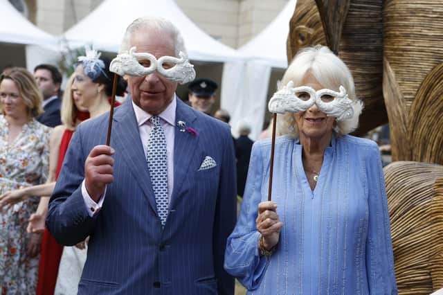 King Charles III and Queen Camilla pose with masquerade masks as they attend the Animal Ball at Lancaster House this week