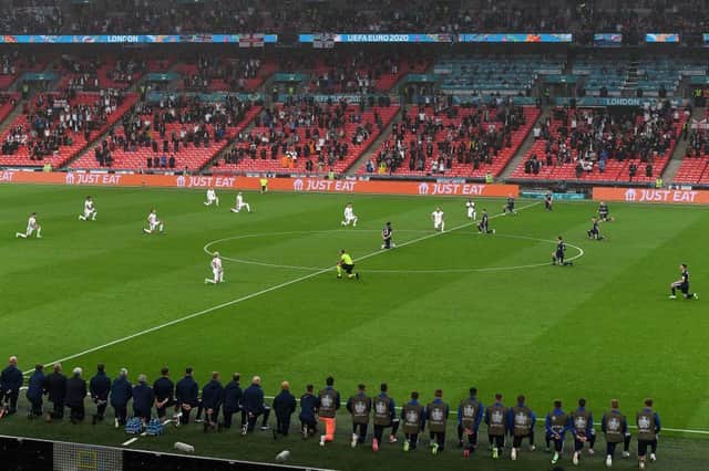 England and Scotland players take a knee in support of racial equality before their match at Euro 2020. Picture: Getty