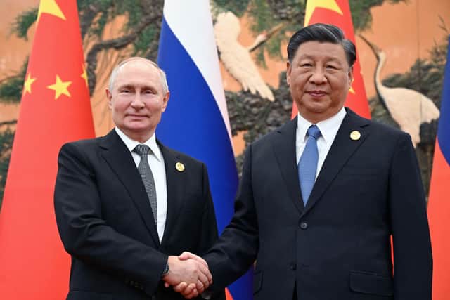 Russia's President Vladimir Putin and Chinese President Xi Jinping shake hands during a meeting in Beijing in October (Picture: Sergei Guneyev/pool/AFP via Getty Images)