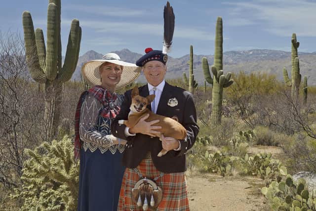 Richard McBain of McBain, 23rd Chief of the Clan MacBean, with his partner Lisa MacFarlane and their dog, Rex, surrounded by the saguaro cacti which surround his home in Arizona.