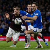 Rangers' Ben Davies fouls Hearts' Stephen Kingsley.