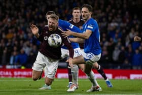 Rangers' Ben Davies fouls Hearts' Stephen Kingsley.
