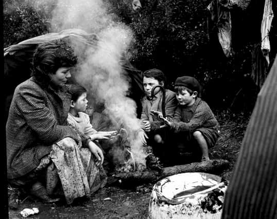 The Johnstone family of travellers huddle round the fire at their camp near Pitlochry  in 1958. PIC: TSPL.