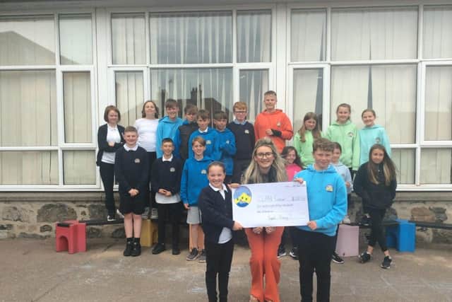 Newburgh Mathers Primary School pupils presented the cheque to Clan Cancer Support