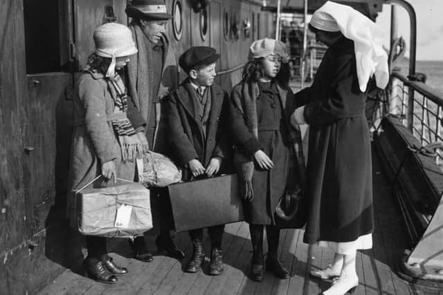 A nurse inspecting a group of children before boarding SS 'Marloch'. PIC  (Photo by Topical Press Agency/Getty Images)