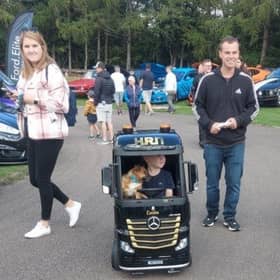 Young driver (and assistant) admires the displays.