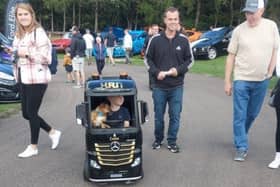 Young driver (and assistant) admires the displays.