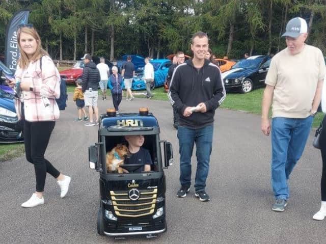 Young driver (and assistant) admires the displays.