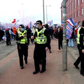 Police arrive at the Ibrox Stadium as fans gather to celebrate Rangers winning the Scottish Premiership title.
