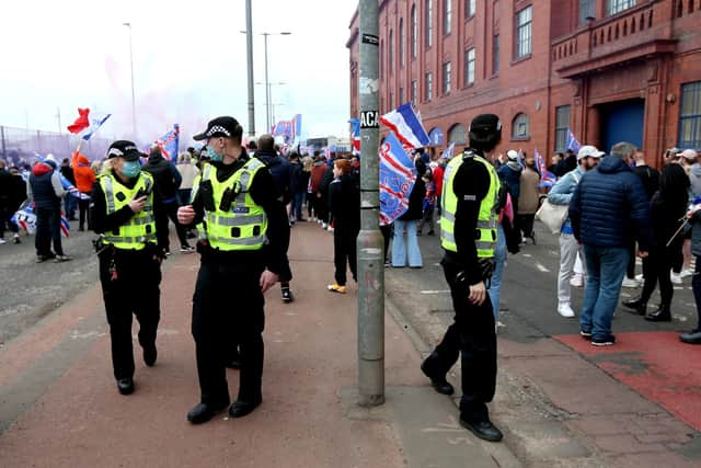 Police arrive at the Ibrox Stadium as fans gather to celebrate Rangers winning the Scottish Premiership title.