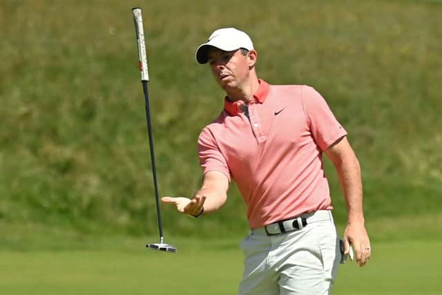 Rory McIlroy tries to catch his putter after a missed attempt during the third round of the 149th Open. Picture: Glyn Kirk/AFP via Getty Images.