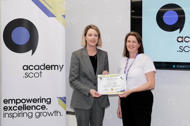Education Secretary Jenny Gilruth hands over a certificate of recognition to Cheryl Hill of One Parent Families Scotland at the launch of academy.scot.