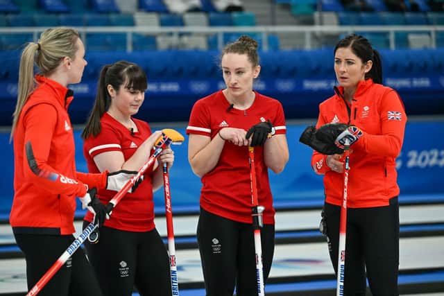 Britain's athletes react after their defeat during the women's round robin session 1 game of the Beijing 2022 Winter Olympic Games curling competition between Britain and Switzerland at the National Aquatics Centre in Beijing on February 10, 2022. (Image credit: Lillian Suwanrumpha/AFP via Getty Images)
