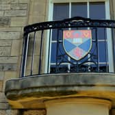 The crest from the University of St Andrews. Funding for universities and colleges has been cut by 46 million pounds