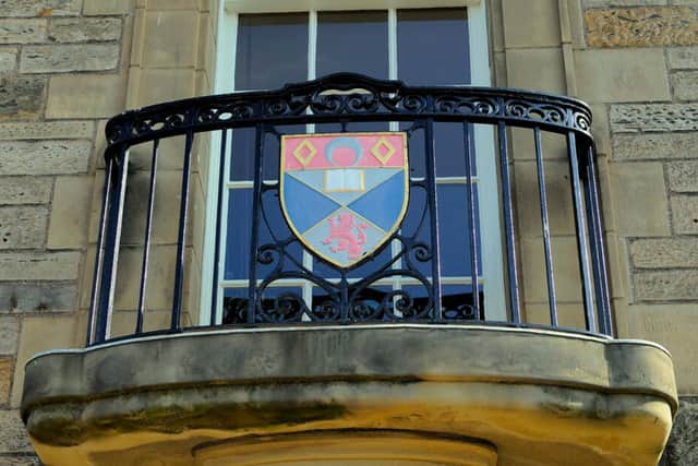 The crest from the University of St Andrews. Funding for universities and colleges has been cut by 46 million pounds