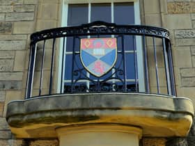 The crest from the University of St Andrews. Funding for universities and colleges has been cut by 46 million pounds
